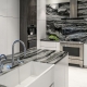 contemporary black and white kitchen with marble waterfall countertop and apron front sink, interior design by Kim Gwozdz, Arizona