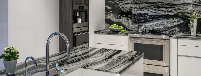 contemporary black and white kitchen with marble waterfall countertop and apron front sink, interior design by Kim Gwozdz, Arizona